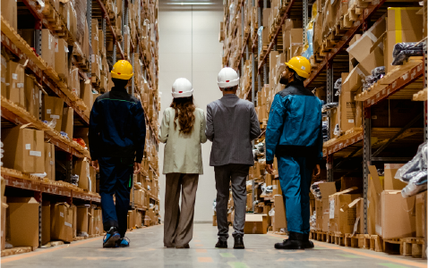 group of people standing in a warehouse 