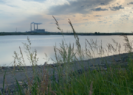 image of a body of water with Jeffery Energy Center in the background