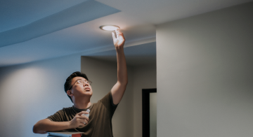 a man replacing a lightbulb