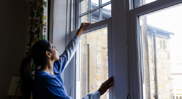a woman checking window seals